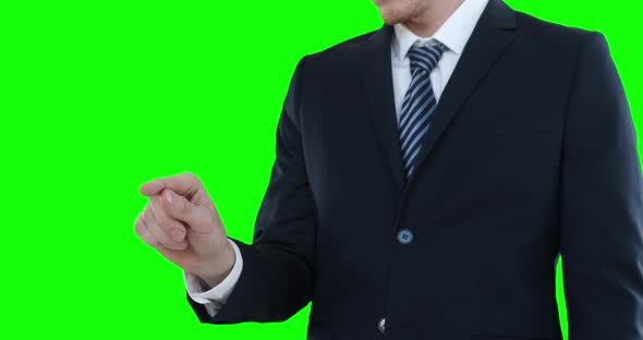 Mid section of a Caucasian man raising hand on green background alt