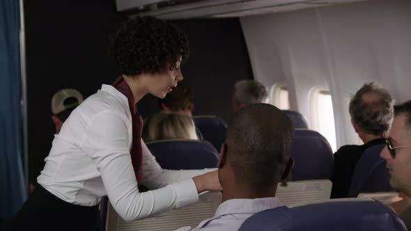 Airliner stewardess passing out drinks