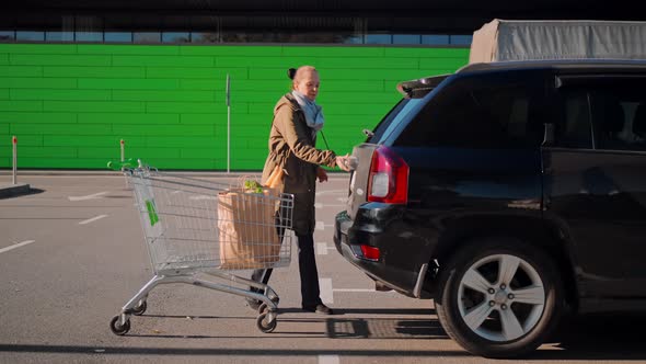 Female Customer on Parking Area Near Store alt