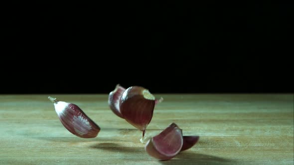Garlic clove pieces bouncing in ultra slow motion  alt