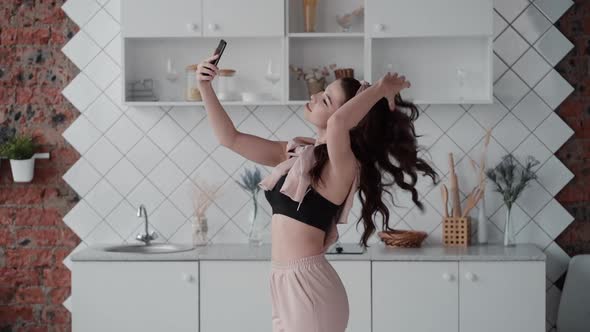 Woman Recording Herself Dancing Sexy at Home. Young Female Filming Video Selfie Jumping, Being Happy