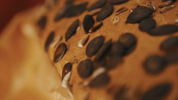 Close Up of Homemade Bread with Pampkin Seeds Baking in the Owen. Slow Motion Shot with Shallow alt