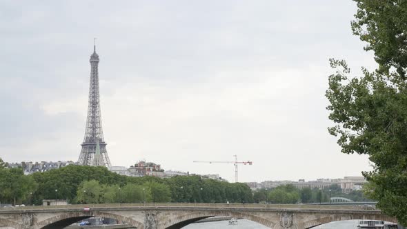 Parisian and French famous Eiffel tower near river Seine by the day slow tilt 4K 2160p 30fps UltraHD alt