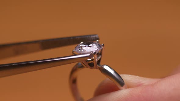 Close Up of Jeweler Inserts Diamond