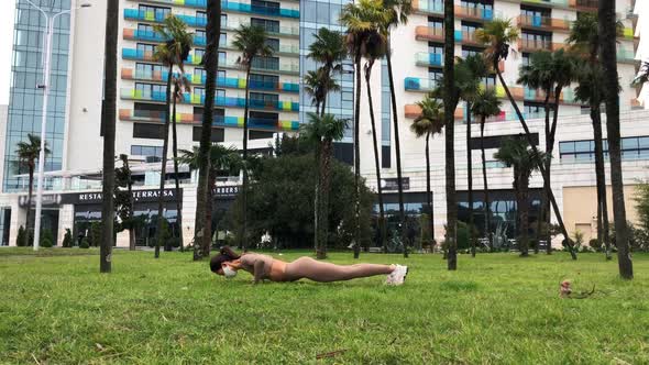 Woman on the Face Mask Doing Workout in the City