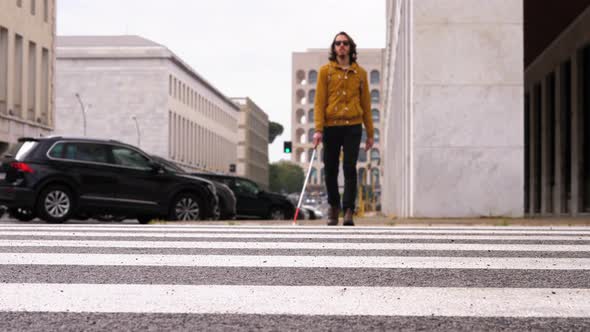 health cronic condition - disabled young man crosses the street alone alt