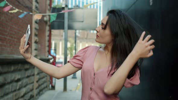 Portrait of Attractive Young Asian Lady Taking Selfie with Smart Phone Camera Outdoors alt