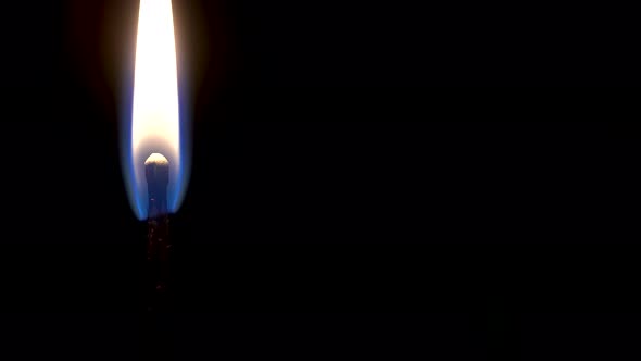 One Match Is Burning On A Black Background, Close Up