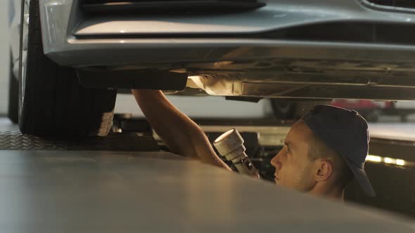 Car suspension test at automobile service. Inspection of the undercarriage 