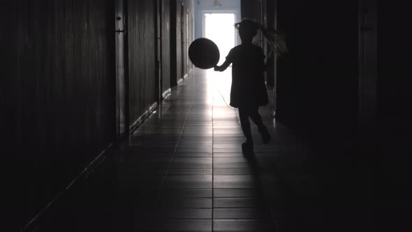 Silhouette of Girl Running with Balloon along Hallway