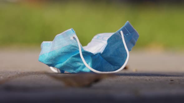 Protective Medical Mask Used and Thrown Away on City Street. Ecological Problem After Pandemic of alt