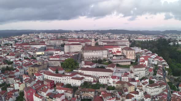Aerial drone view of Coimbra city and Mondego river at sunset alt