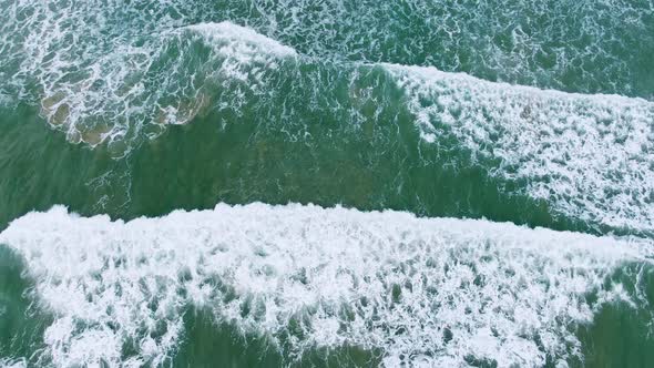 An aerial view of the waves at low tide creating layers.