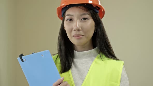 Asian Woman Builder in Protective Clothing