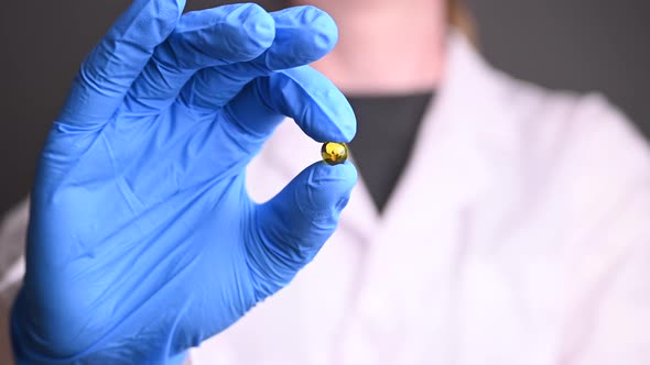 the Doctor in a Robe and Gloves Holds the Tablet in His Hands. Treatment and Prevention of Viruses alt