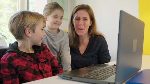 Mother and children with laptop