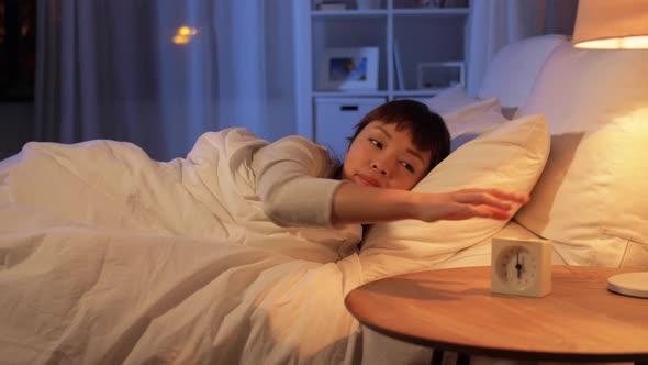 Woman Awaking Because of Alarm Clock at Night alt