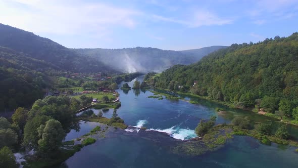 Aerial view of Una river waterfalls and green forested landscape, Bosnia alt