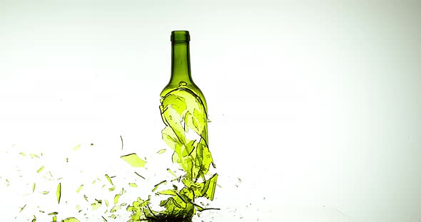 900070 Bottle of White Wine Breaking and Splashing against White Background, Slow motion 4K alt