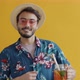 Joyful Arab Tourist Wearing Vacation Clothing Drinking Cocktail and Dancing Having Fun - VideoHive Item for Sale