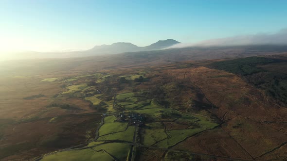 Aerial view of green and brown countryside in Wales on a frosty winter mornin