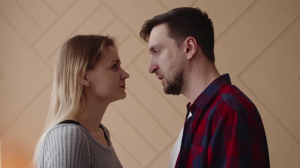 Husband with Wife After Quarrel Stand and Look Into Each Other's Eyes Opposite Each Other They Touch alt