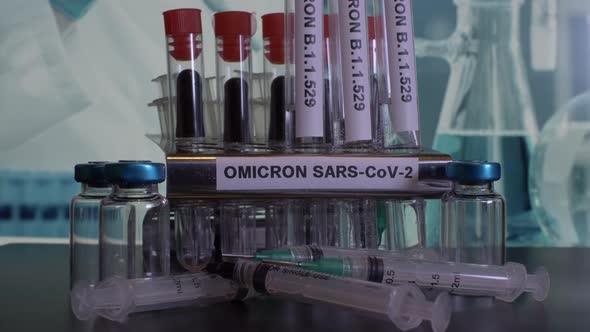 Taking test tubes with Omicron label for sample collection and testing at laboratory. alt