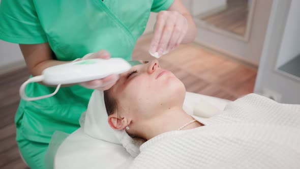 Beautician Woman Procedure for Cleansing and Rejuvenating Face in Beauty Salon alt