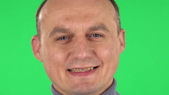 Man Looking at the Camera and Laughing. Close Up. Green Screen alt