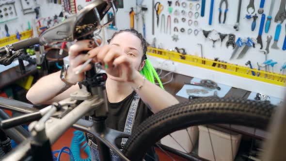 Female Mechanic Detaching Bicycle Seat