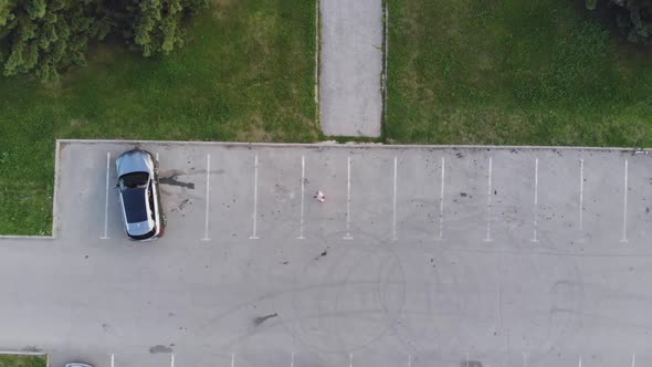 Aerial Drone Shot of Young Casual Businessman Uses Smartphone