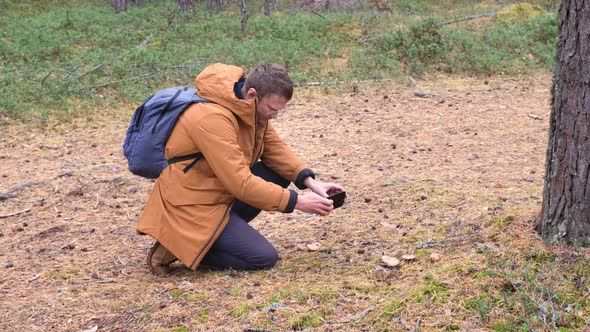 Tourist Taking a Photo of Mushrooms in the Autumn Forest