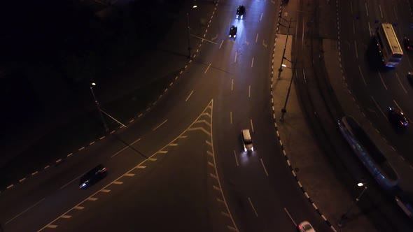 City streets aerial look down, cars on night road