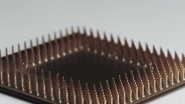 The Computer Processor CPU with Gold Plated Contacts Spins on White Background alt