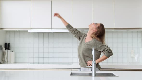 Woman Dancing in Kitchen