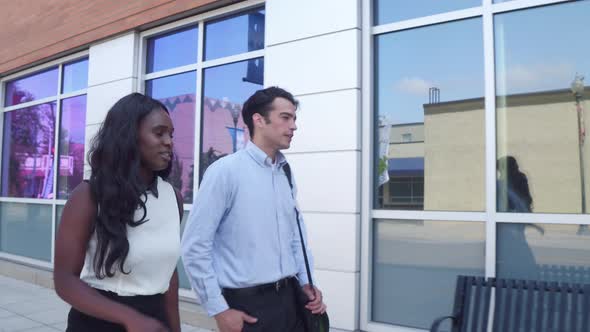 Businessman and businesswoman walking together