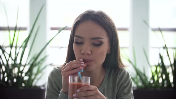 Woman On Diet Drinking Detox Smoothie Indoors alt