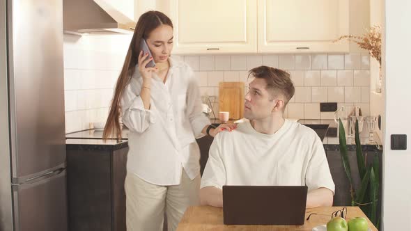 Beautiful Couple at Home, Support and Care From a Loved One During Work at Home. alt