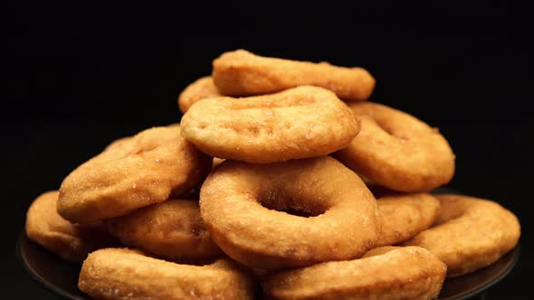 A pile of the doughnuts rotation on a black background