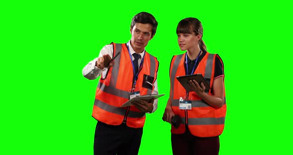 Front view of a site workers using digital tablet with green screen alt