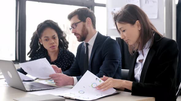 Intelligent Pretty Caucasian Young Adult Brunette Business Lady in Suit Sitting at the Workplace in alt