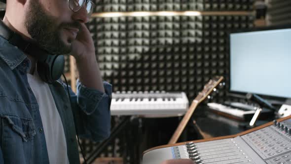 Sound Engineer Mixing Music in Recording Studio alt