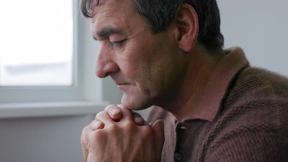 Portrait of Serious Elderly Man in His Home alt