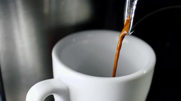 Pouring Coffee Into Cup From Electric Coffee Machine Shooting in  Resolution in Slow Motion