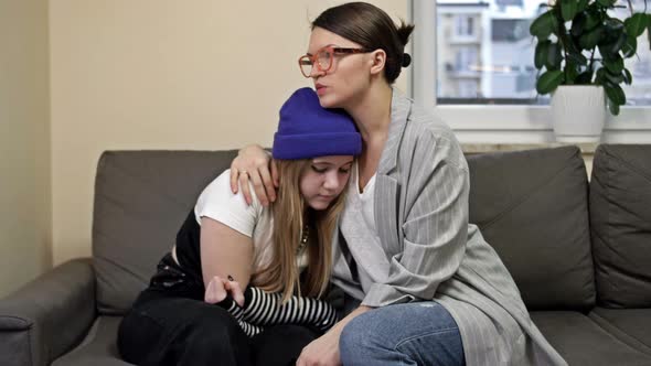 Mom Hugs Her Teenage Daughter and Comforts Her alt