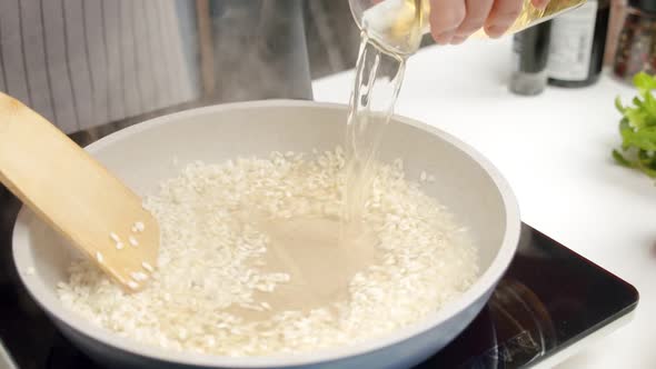 Crop woman preparing risotto in kitchen alt