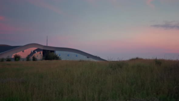 Beautiful Grass Field Landscape Grow By Big Building alt