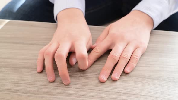 The Hands of Teenager Who Pulls the Fingernails