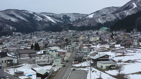aerial of nozwa onsen town in the mountains of nagano japan during winter alt
