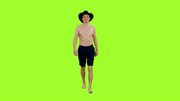 Young Man With Naked Torso Walks in Cowboy Hat 